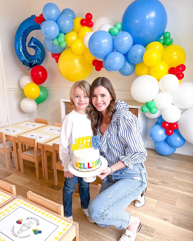 mom with son in front of birthday balloon garland and number six