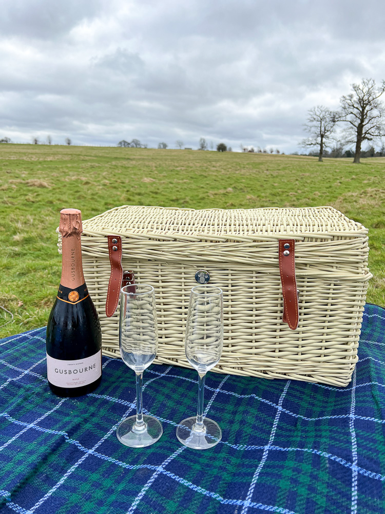 picnic hamper and champagne english countryside