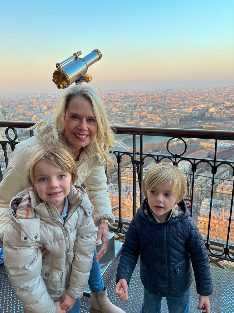 woman with two little boys at the top of the eiffel tower