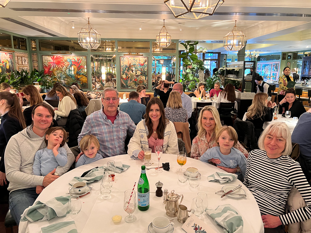 family group around dining table the ivy chelsea london