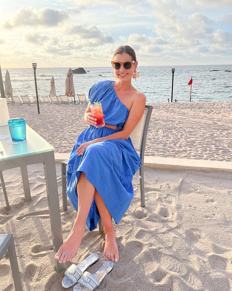 woman sitting with a cocktail beachside