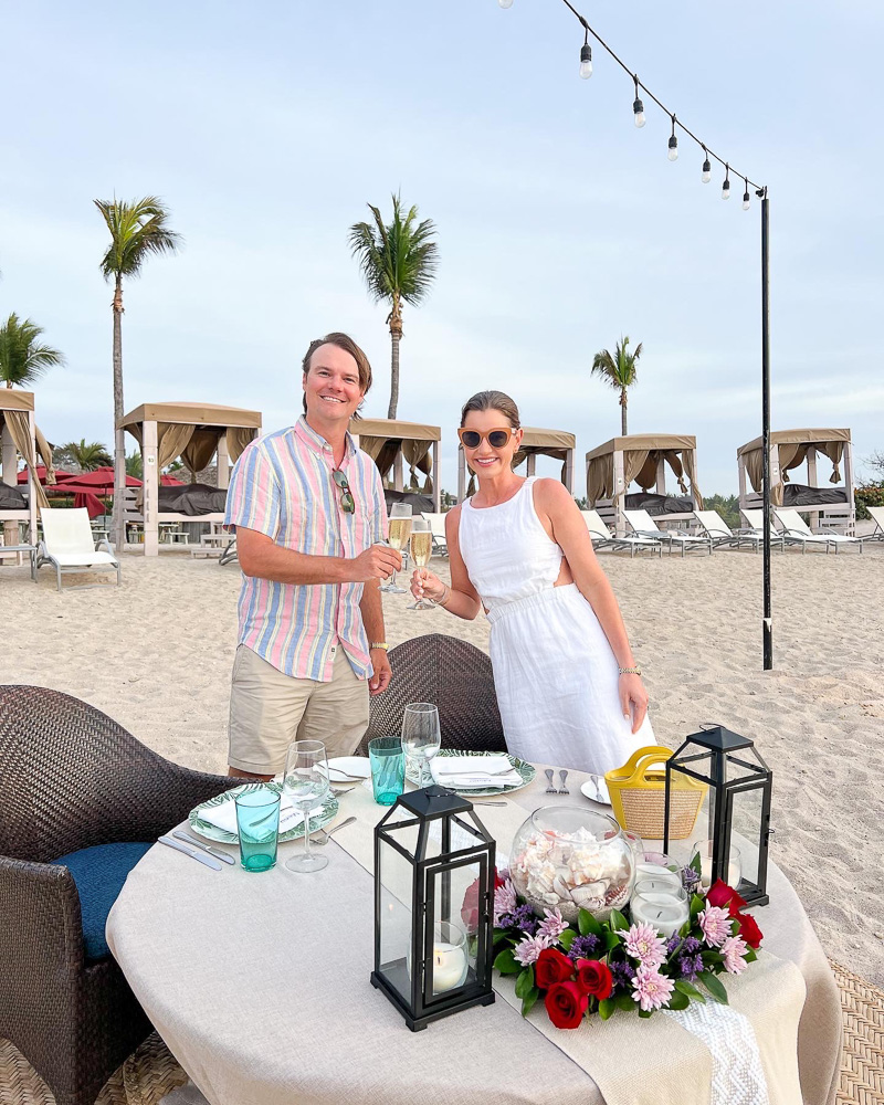 couple toasting with champagne at beachside dinner