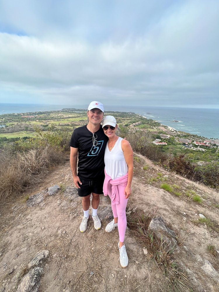 couple on hill top with view to ocean