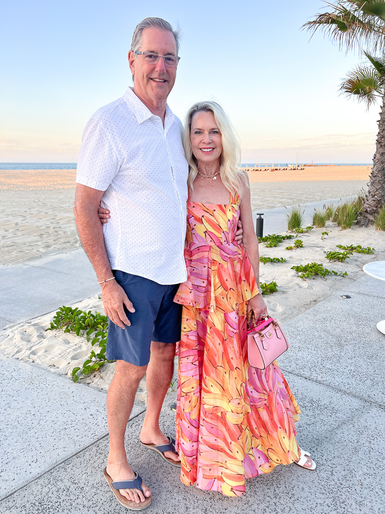 couple standing next to beach