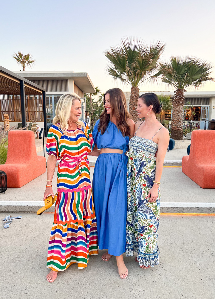 three women in colorful maxi dresses