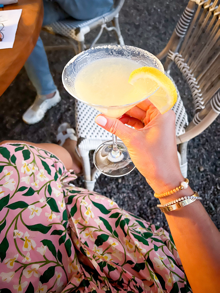 woman holding yellow cocktail