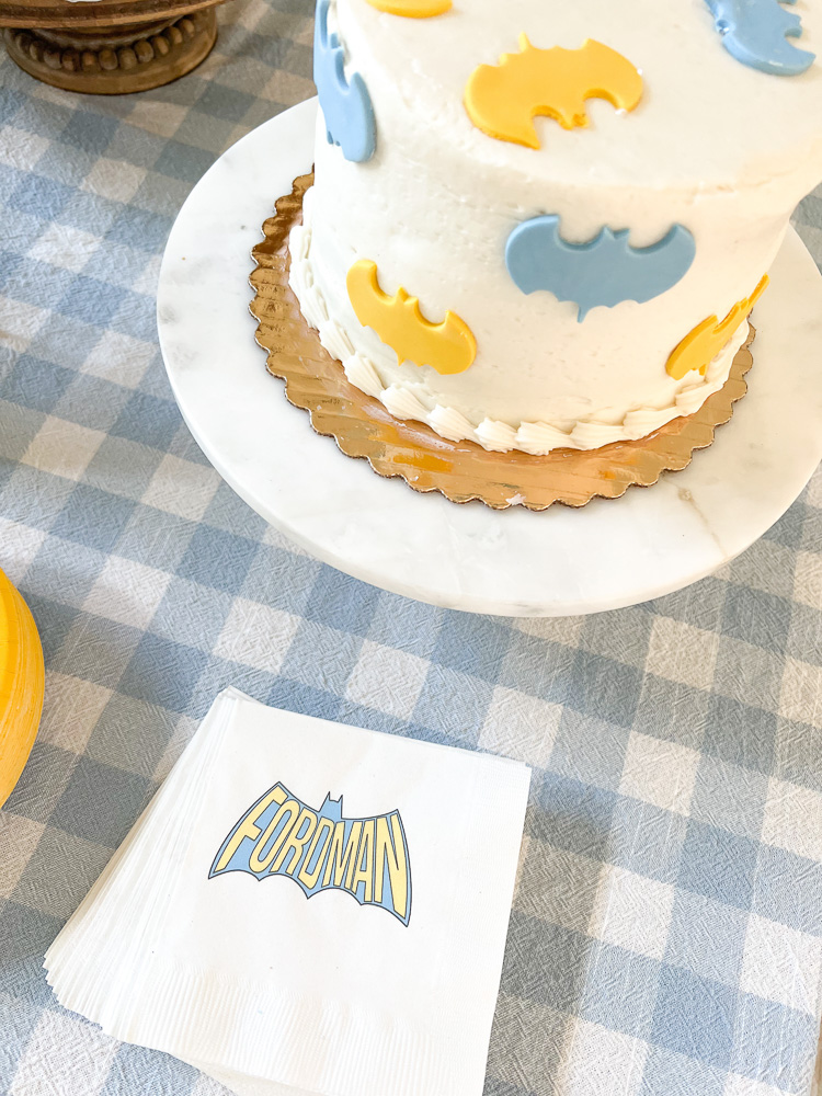 ble and yellow batman cake with personalized napkins