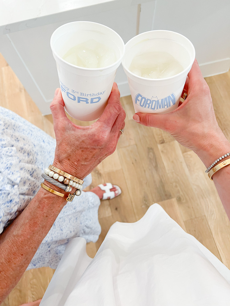 two women holding personalized plastic tumblers