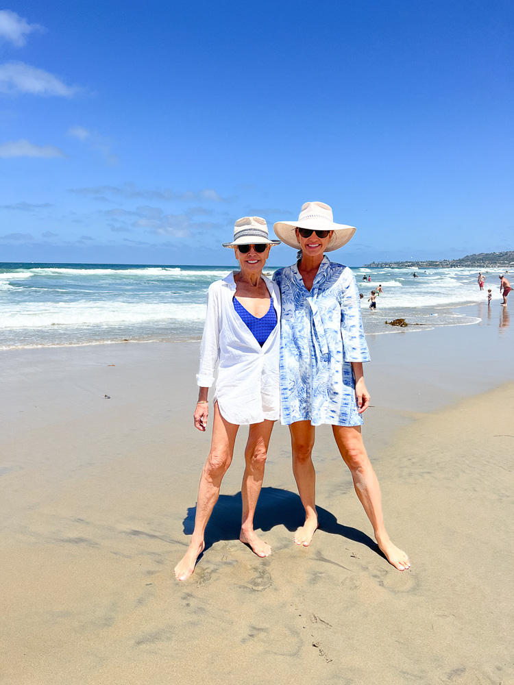 two women in beach cover-ups and straw hats
