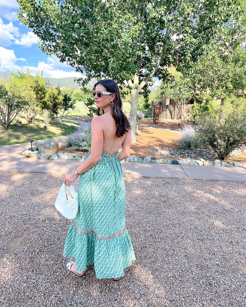 woman in green maxi dress with open back