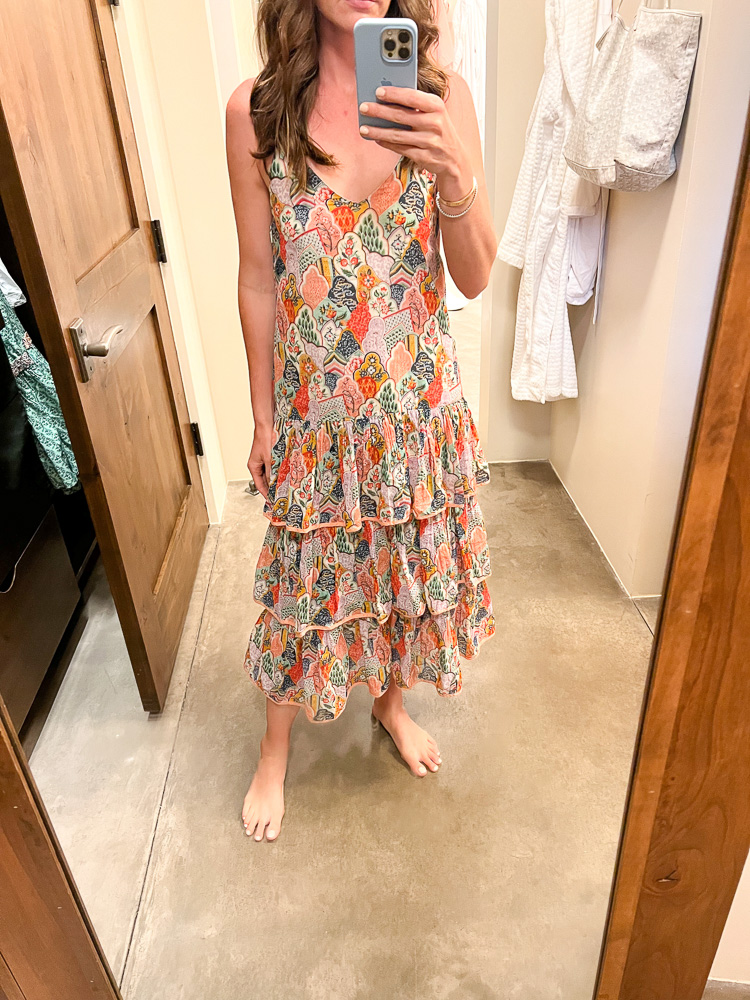 woman standing in front of mirror in floral maxi dress
