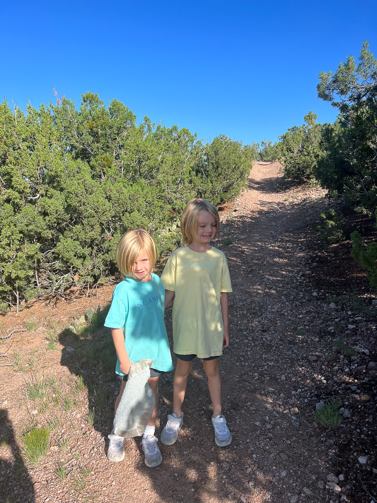 two little boys standing on hiking path
