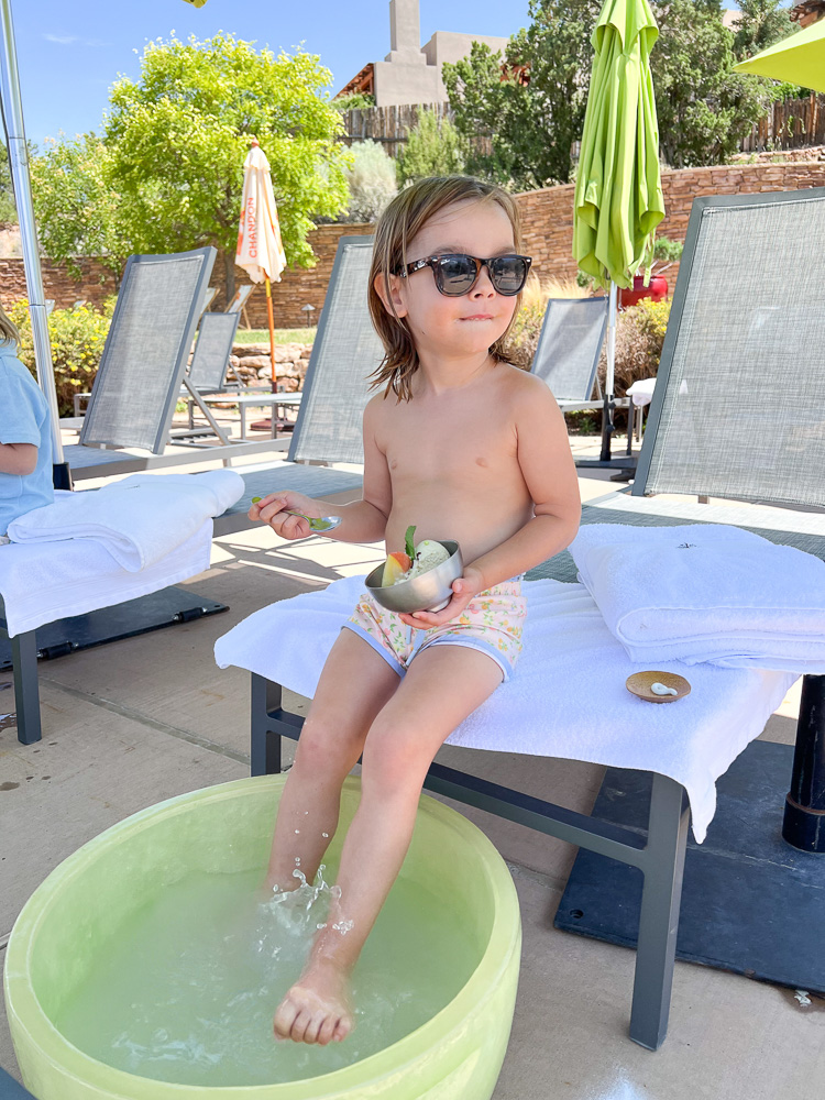 little boy poolside with sunglasses and ice cream