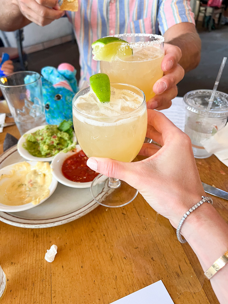 toasting with margaritas at a restaurant