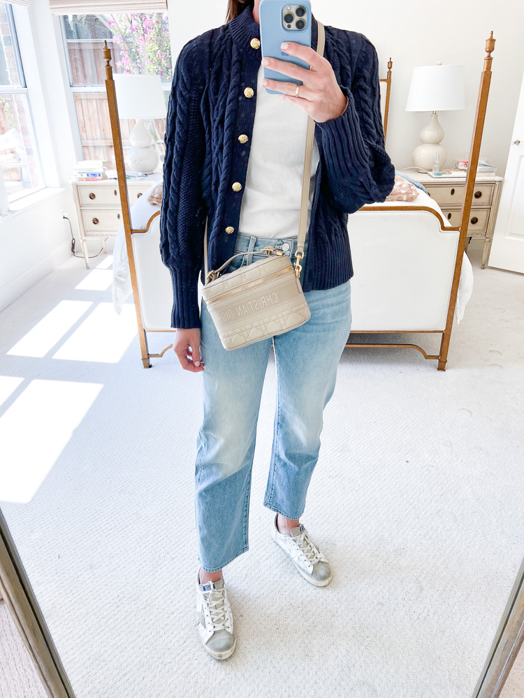 woman wearing navy blue cardigan white t-shirt jeans and sneakers