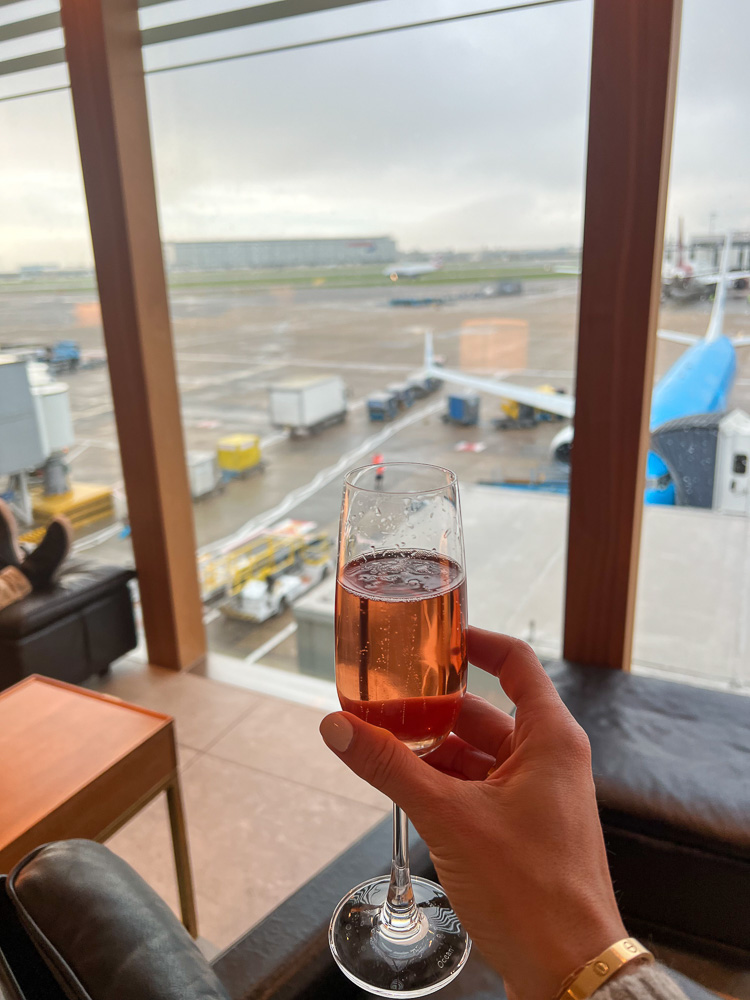 rose champagne in a flute looking out at the airfield