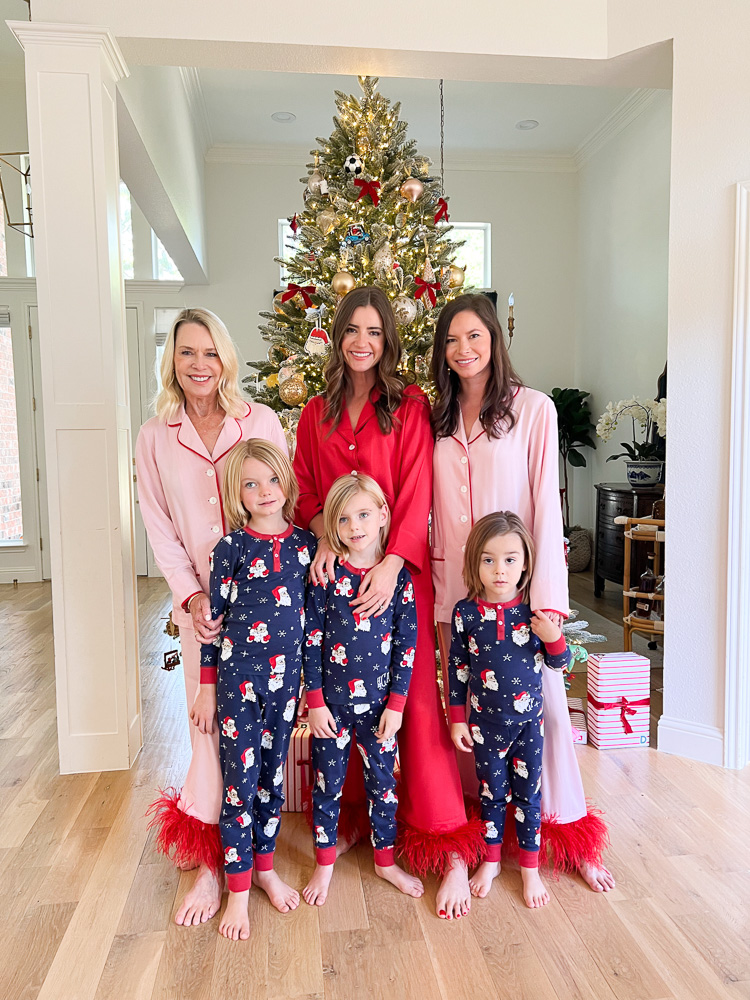 three women with three little boys standing in front of christmas tree in matching
