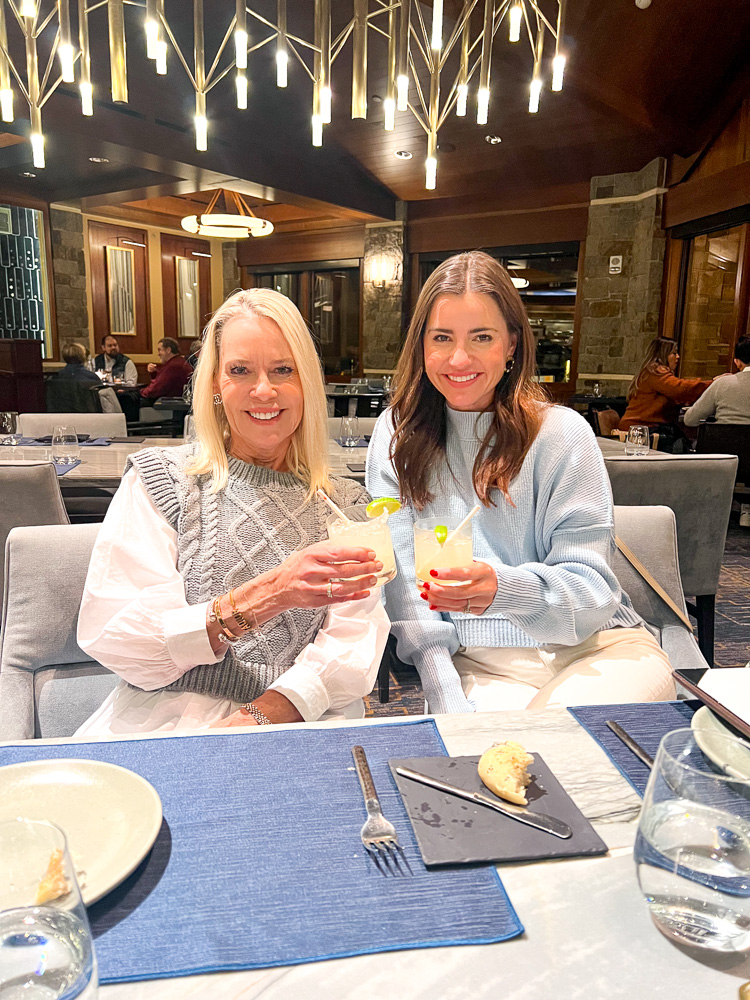 two women toasting with drinks at westbank grill FS jackson hole