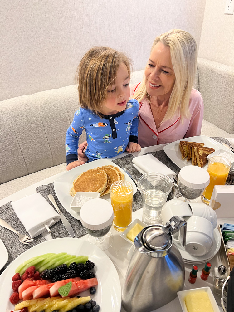 woman and toddler eating room service breakfast