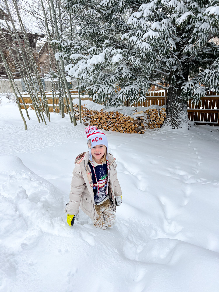 toddler boy standing in the snow