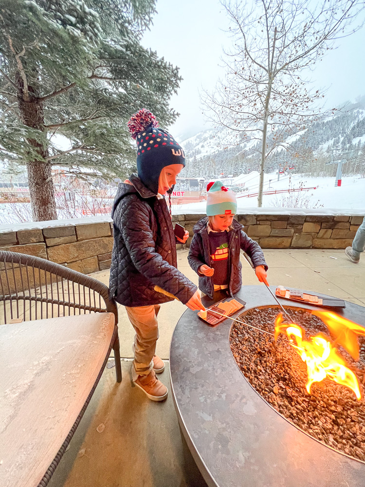 two little boys toasting marshmallows for s'mores FS jackson hole