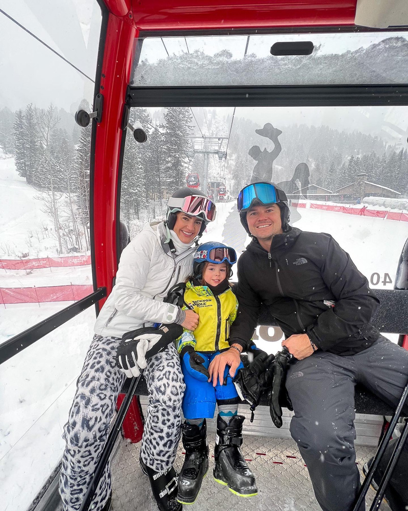 mom, dad and toddler boy on gondola teton village WY
