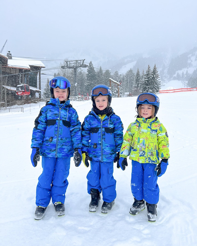three little boys in ski gear standing slopeside teton village
