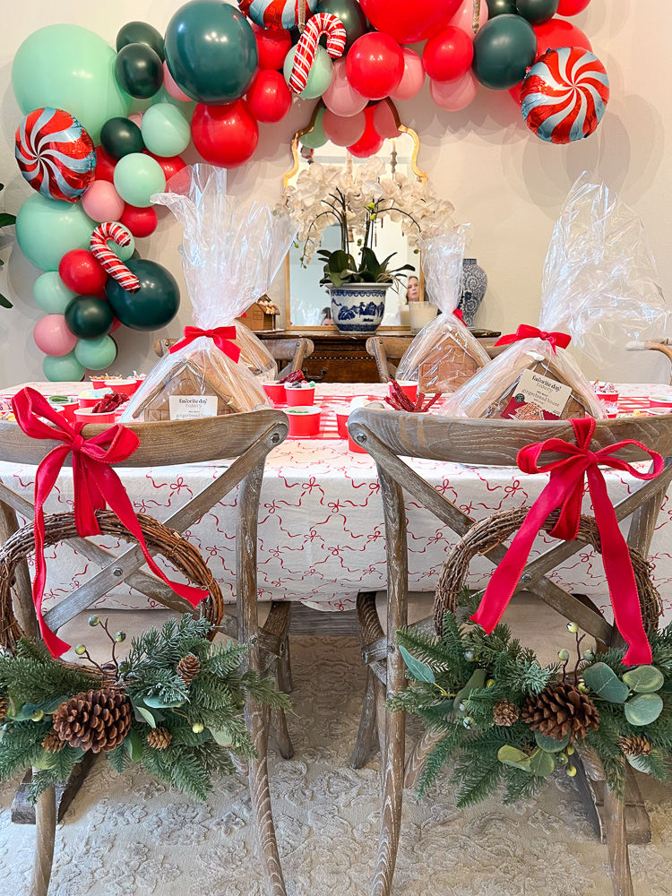 table decorated for Christmas with balloon garland on wall