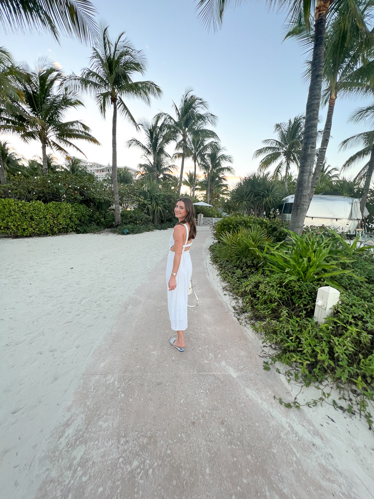 woman in white maxi dress walking in the sand