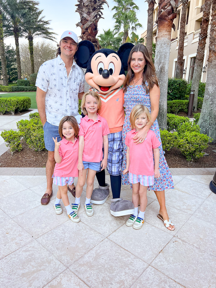 family standing with mickey mouse