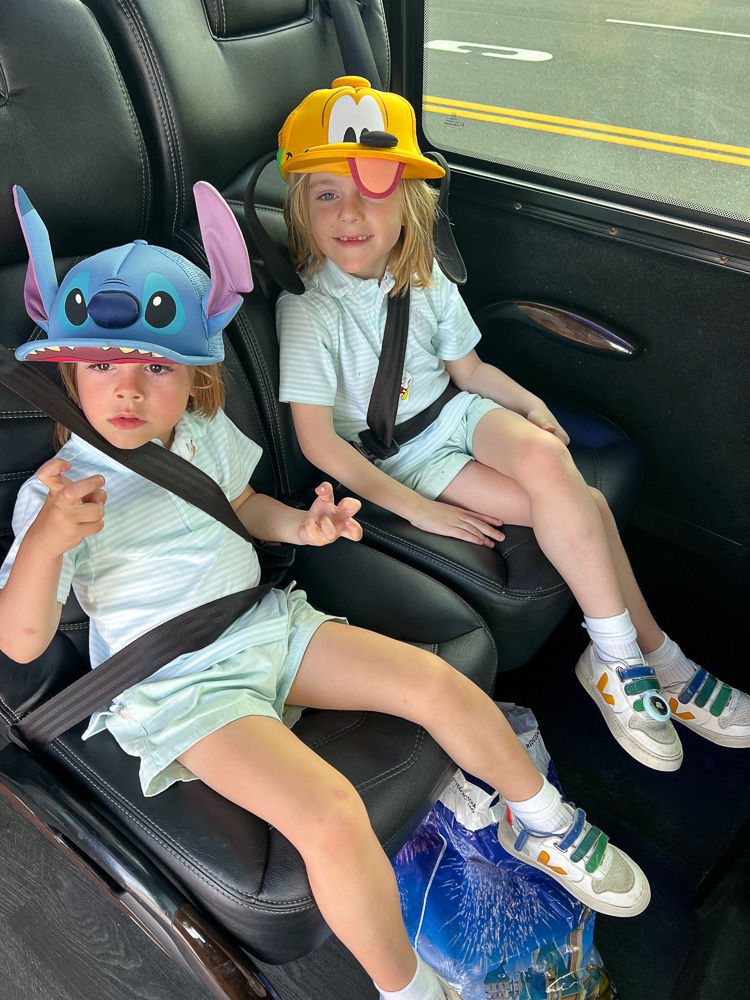 two boys wearing character hats from disney world