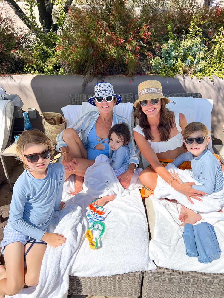 family group on lounge chairs at pool four seasons scottsdale