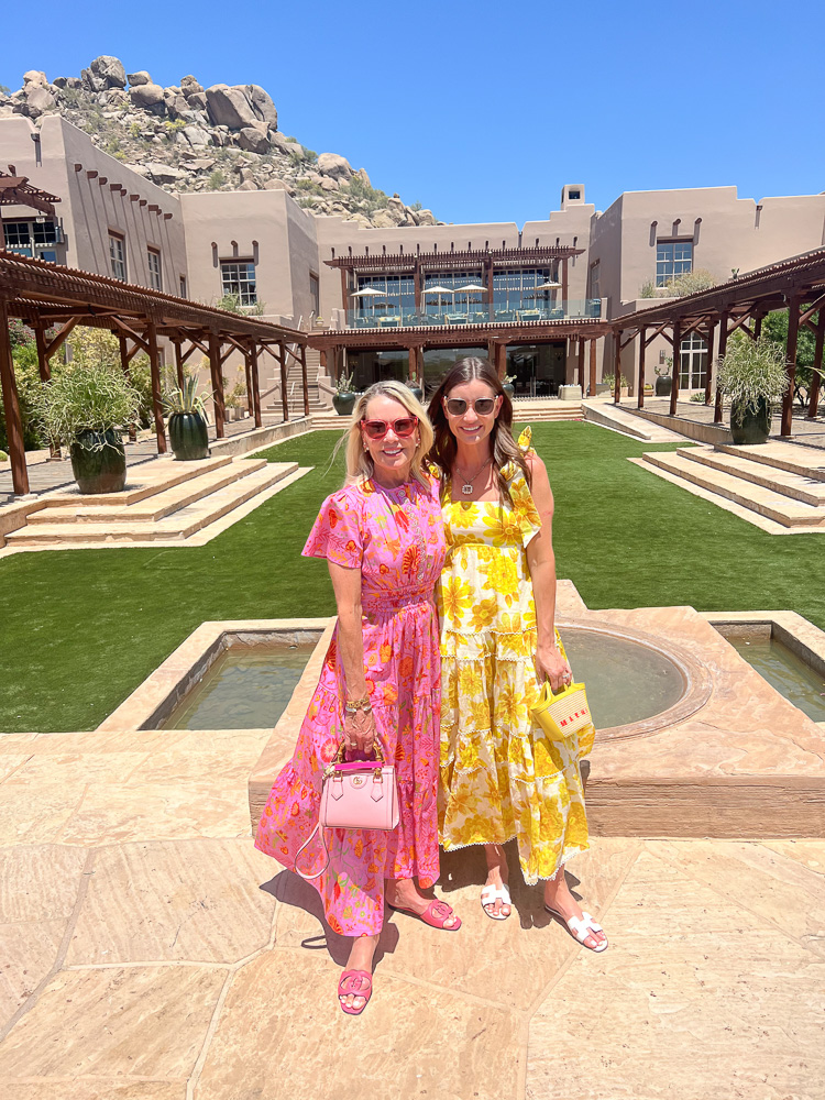 two women in floral maxi dresses standing in front of four seasons scottsdale