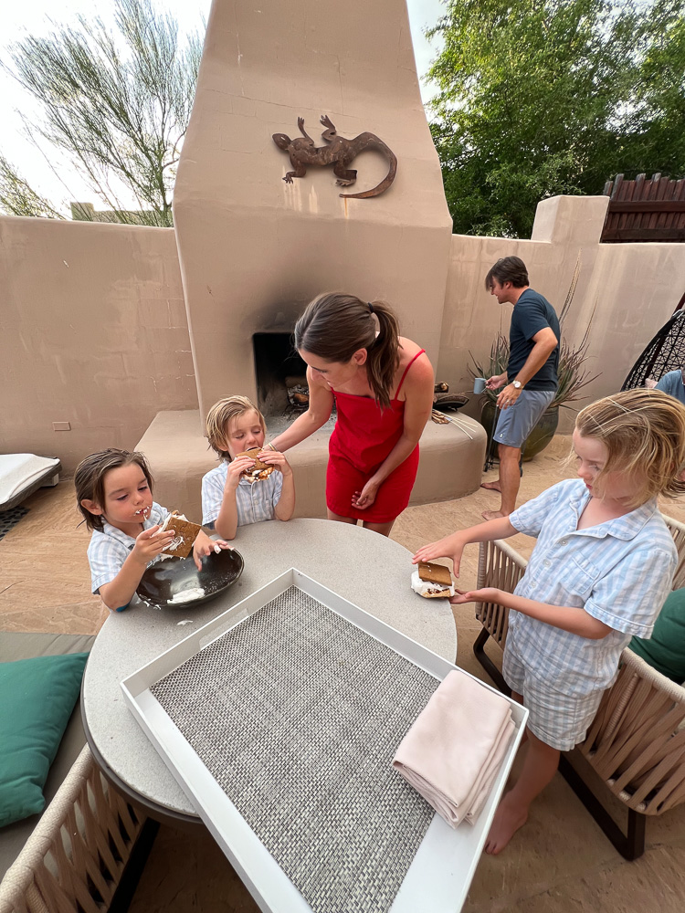 mom and dad and three little boys making s'mores on patio at four seasons scottsdale