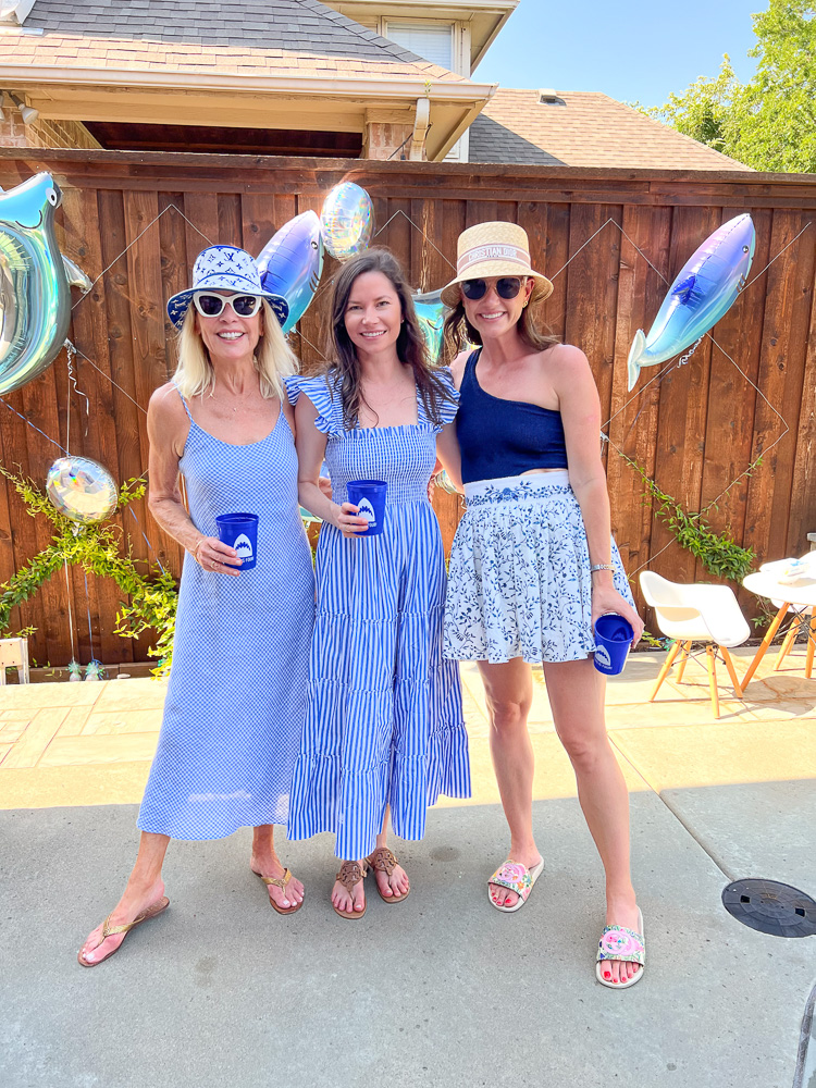 three women in sun dresses at pool party