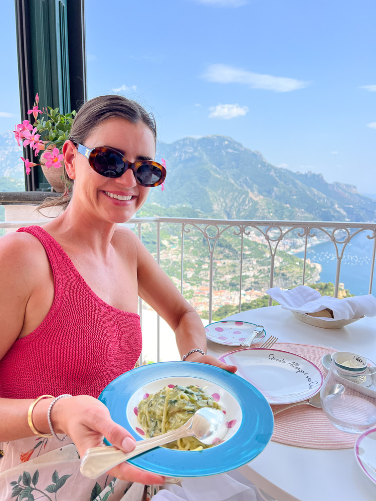 Woman eating pasta with a view from ravello