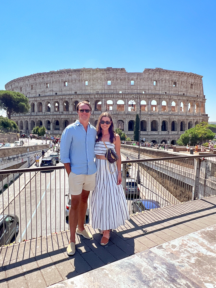 couple standing with a view of colosseum