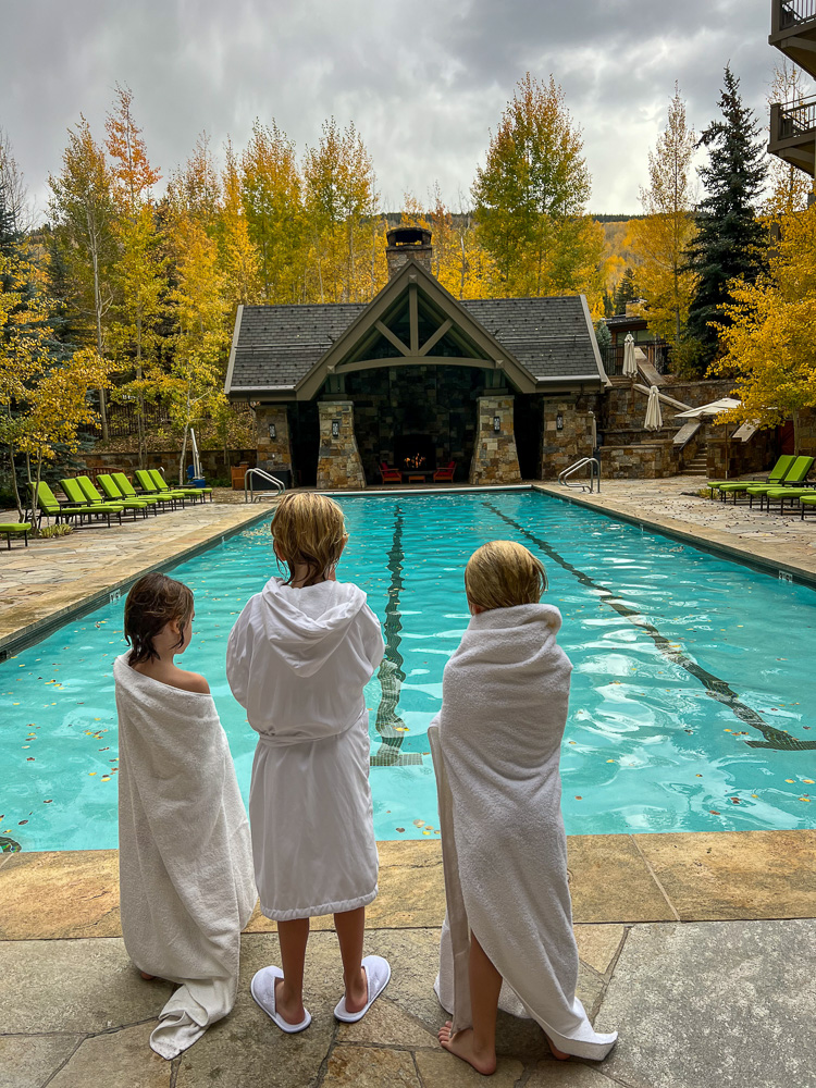 three little boys in pool robes standing poolside four seasons vail