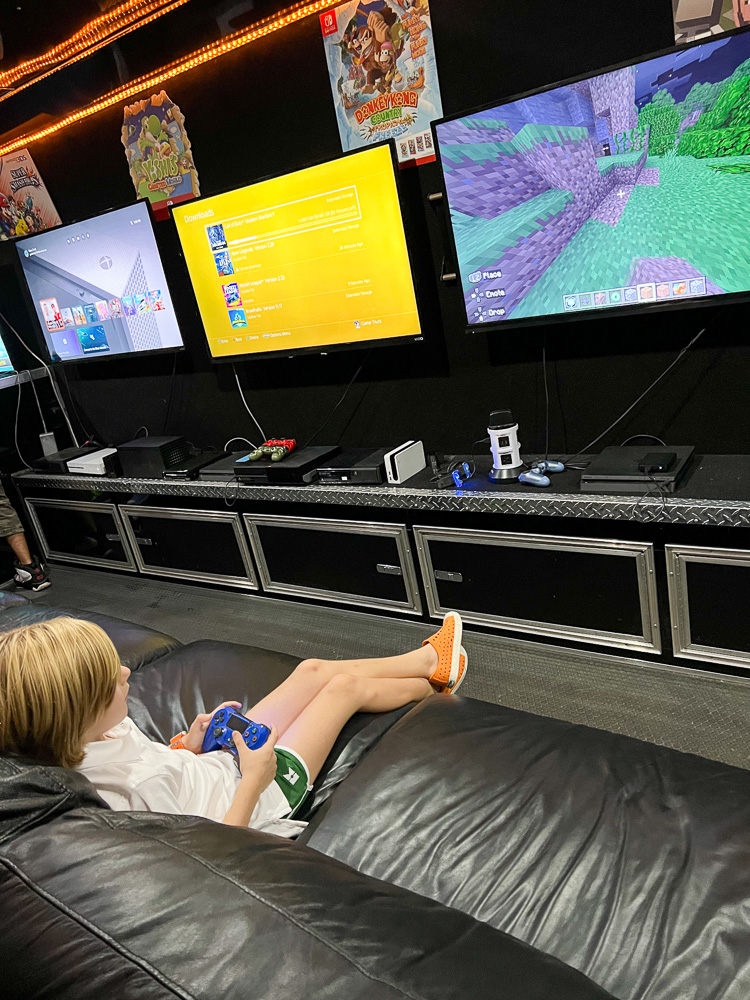 little boy sitting in game truck playing video games