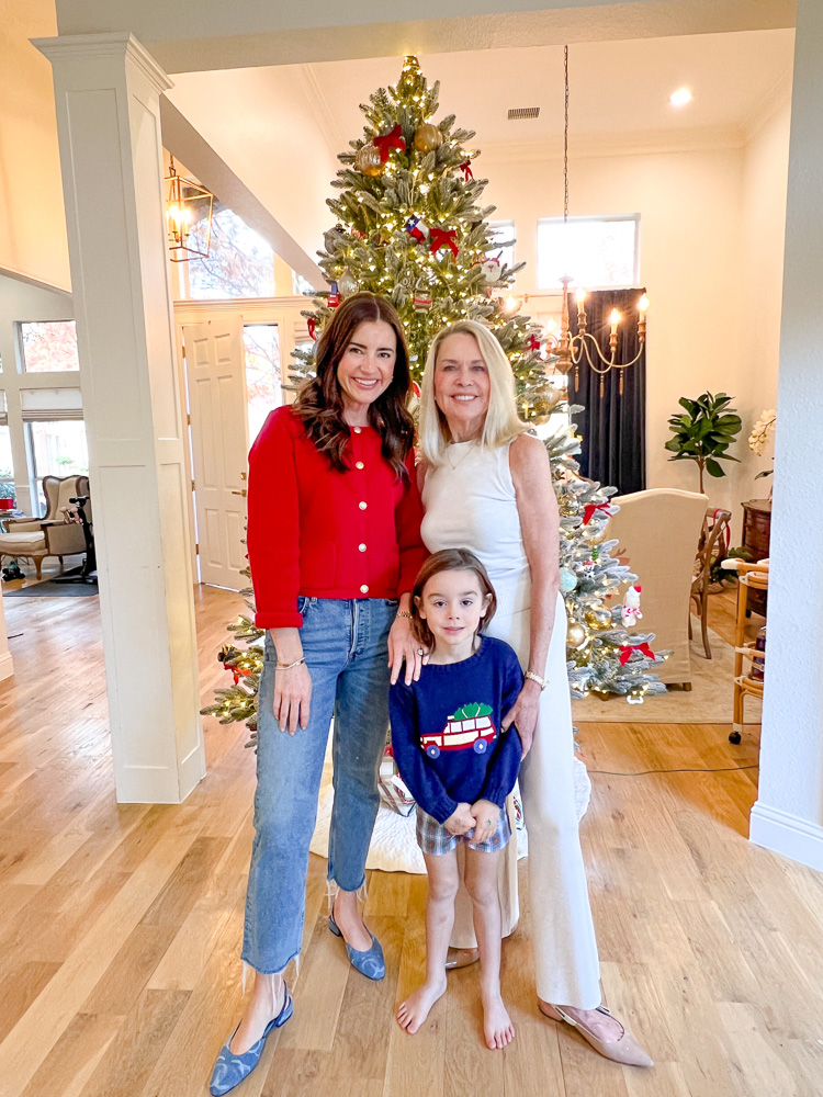 two women with little boy in front of Christmas tree