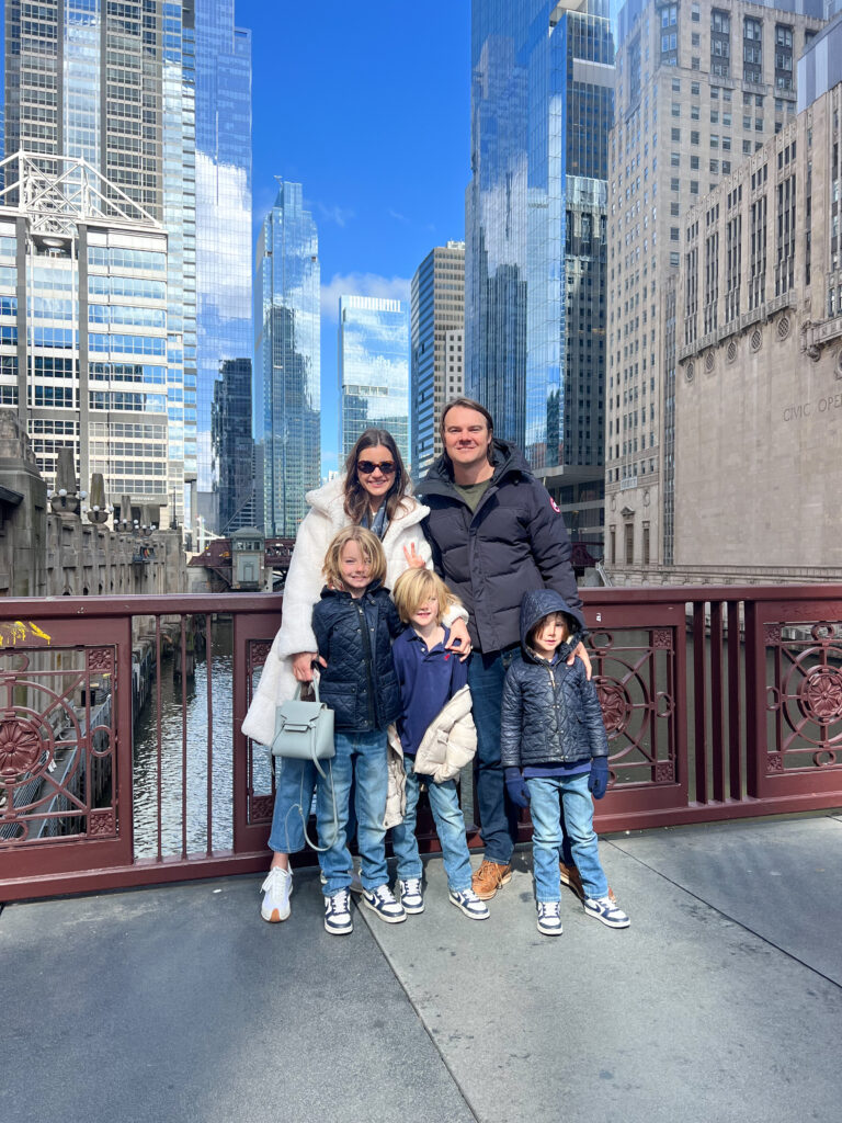 family standing with background of downtown chicago