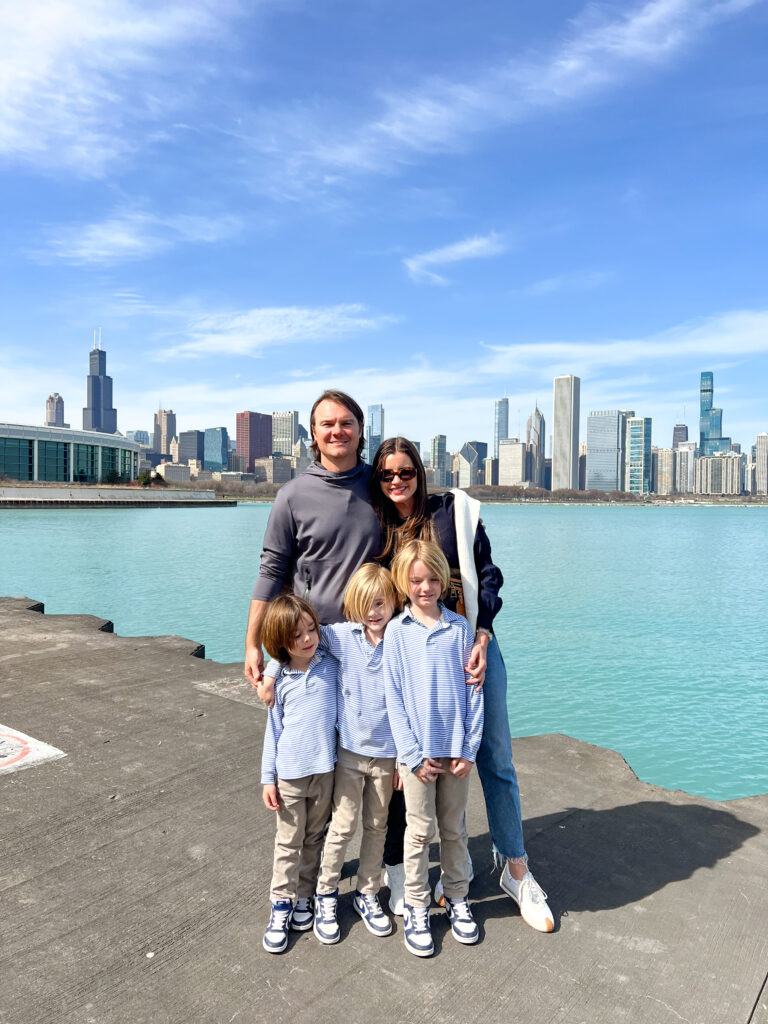 young family posing in front of lake michigan in chicago