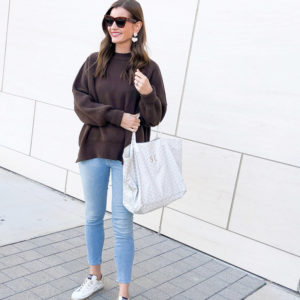 woman wearing brown oversized sweater jeans golden goose sneakers