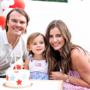 mom and dad with toddler boy and birthday cake