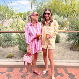two women standing with iced coffee desert landscape four seasons scottsdale
